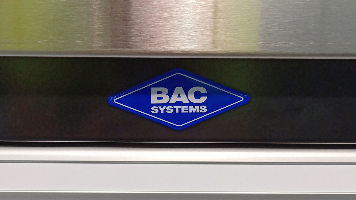 BAC Systems logo sticker affixed to the side of a stainless steel workbench
